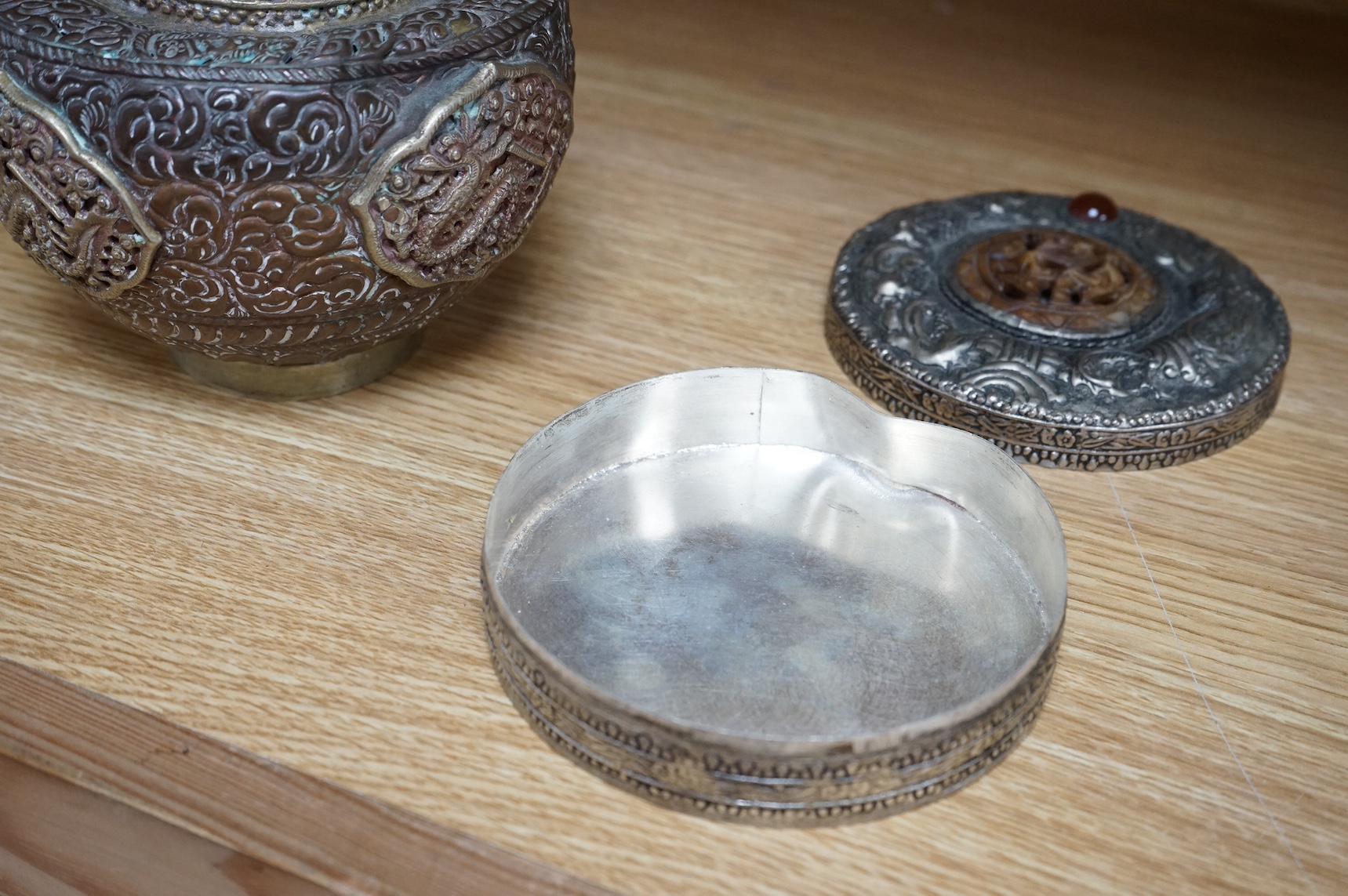 A Tibetan copper and brass pot and a similar box and cover with mirrored interior, largest 19cm high (2). Condition - poor to fair